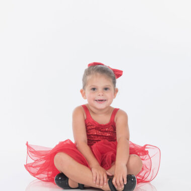 Young girl on floor legs crossed
