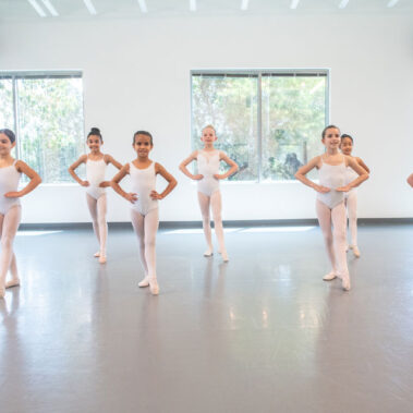 Young girl standing and pointing their toes
