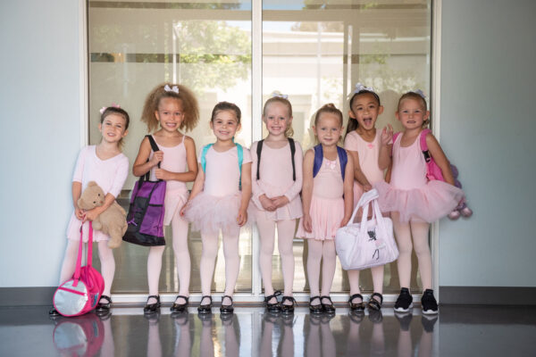 Young little girl dancers posing for a group picture.